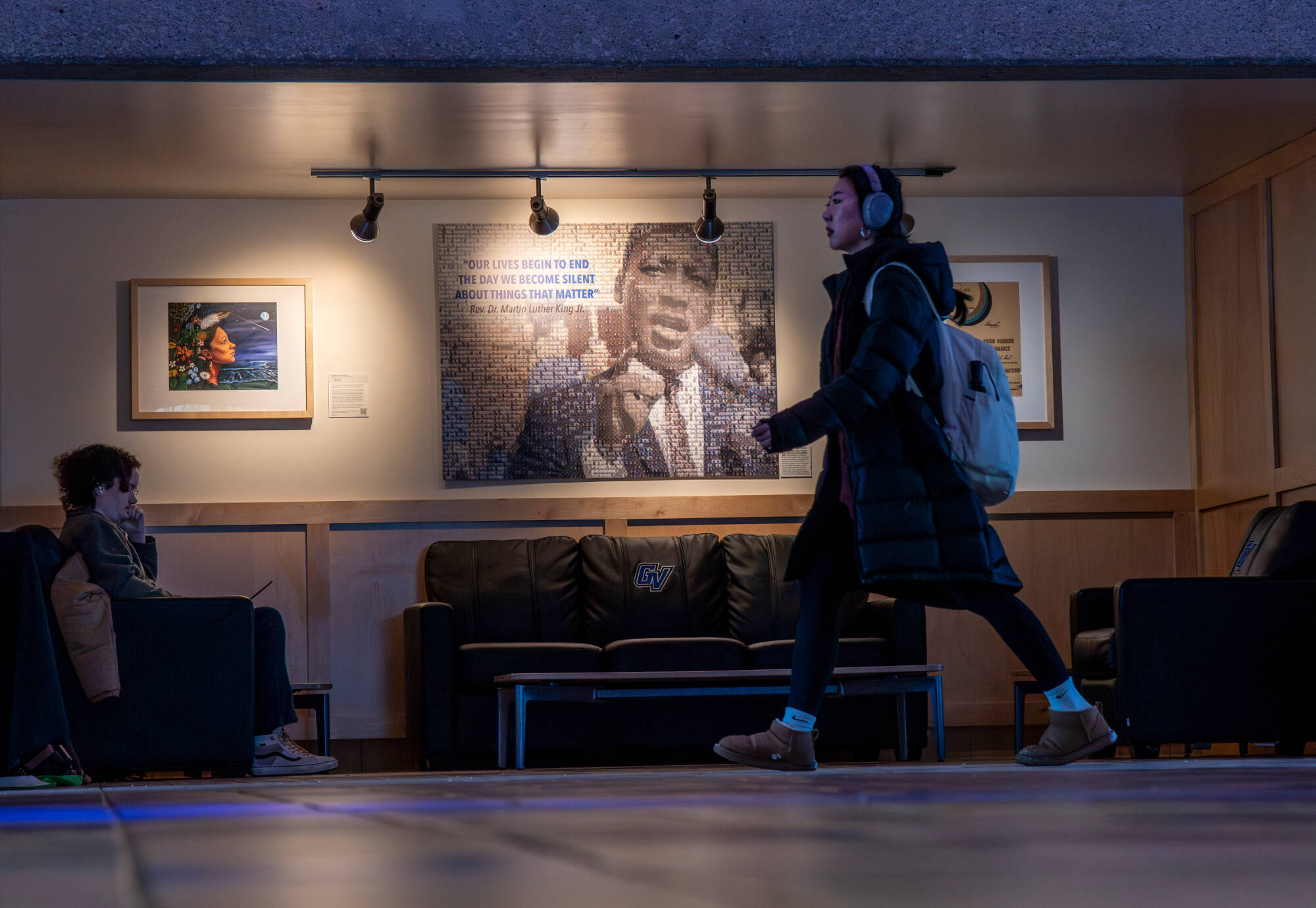 Accounting major Anthony Bassett works near artwork depicting Martin Luther King Jr. inside the Kirkhof Center